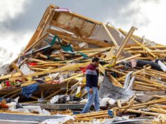 Gopala Penmetsa walks past his house after it was levelled by a tornado near Omaha (Chris Machian/Omaha World-Herald/AP)