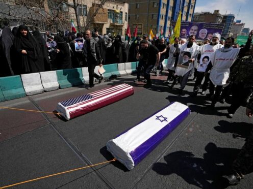 Iranians pull symbolic coffins for the US to mark Quds Day, or Jerusalem Day, in support of Palestinians, in Tehran (Vahid Salemi/AP)