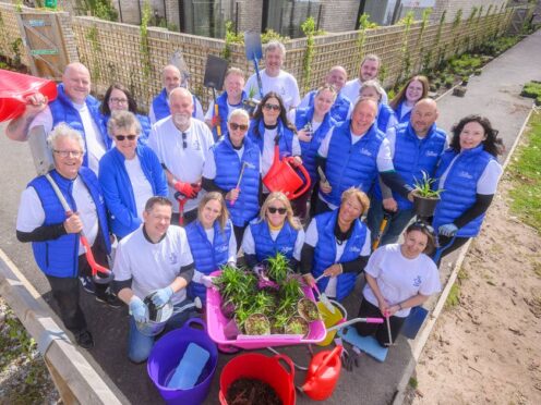 Lottery winners from across the UK help out with gardening at Alder Hey Children’s Hospital (Anthony Devlin/PA)