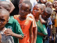 Children line up to receive food at a shelter for families displaced by gang violence, in Port-au-Prince, Haiti (Odelyn Joseph/AP)