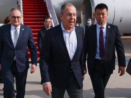 Russian foreign minister Sergey Lavrov, centre, walks from the plane upon his arrival in Beijing, China (Russian Foreign Ministry Press Service/AP)