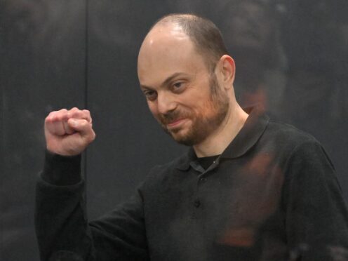 Vladimir Kara-Murza gestures while standing in a defendants’ cage at the Moscow City Court on July 31, 2023 (AP)