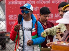 Renowned Sherpa mountain guide Kami Rita, left, returning from Mount Everest after his record 30th successful ascent, arrives at the airport in Kathmandu, Nepal, on Friday (Niranjan Shrestha/AP)
