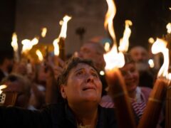 A Christian Orthodox pilgrim holds a candle during the Holy Fire ceremony (AP)