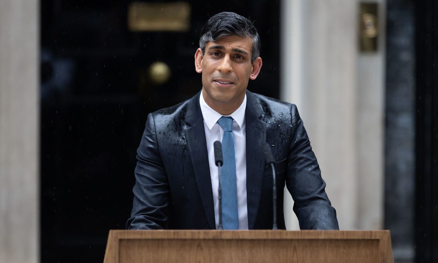 Rishi Sunak. in the rain outside 10 Downing Street.