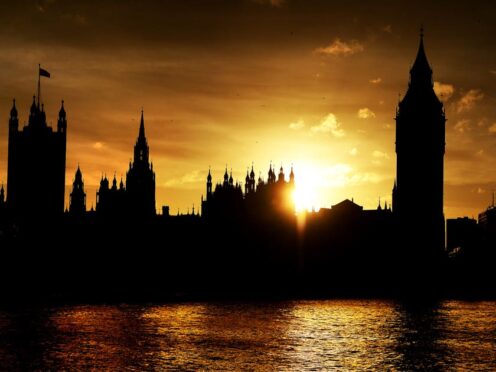 The sun sets behind the Houses of Parliament (Andrew Matthews/PA)