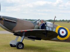 The Prince of Wales sits in a newly restored Supermarine Spitfire Mark I N3200 at the Imperial War Museum in Duxford (John Stillwell/PA)