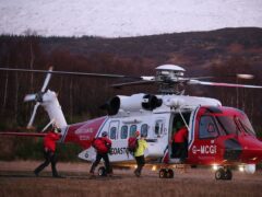 Lochaber Mountain Rescue team board a search and rescue helicopter after an avalanche (Andrew Milligan/PA)