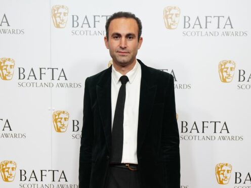 Khalid Abdalla scattered 14,000 sequins at the Bafta TV awards in an anti-war message (Jane Barlow/PA)