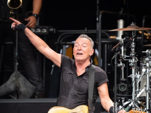 Bruce Springsteen and the E Street Band performing on stage (James Manning/PA)