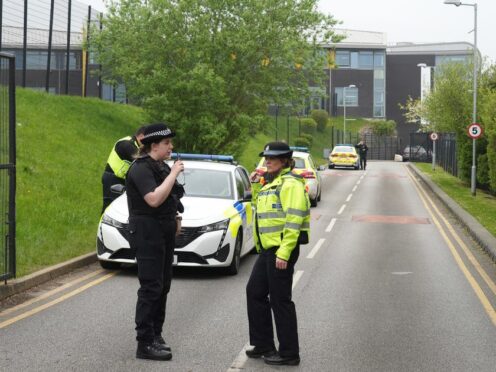 Police stand outside the Birley Academy in Sheffield (Dominic Lipinski/PA)
