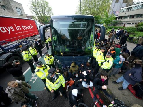 Police try to stop protesters forming a blockade around a coach in Peckham (Yui Mok/PA)