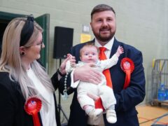 Labour candidate Chris Webb celebrates with his wife Portia and baby Cillian Douglas Webb (Peter Byrne/PA)
