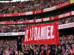 Fans hold up a banner on the 14th minute in memory of 14-year-old Daniel Anjorin, who died following the sword attack in east London on Tuesday (Adam Davy/PA)