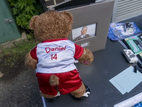 A teddy bear in a football jersey left as a tribute at a vigil at Hainault Underground station car park (Jeff Moore/PA)