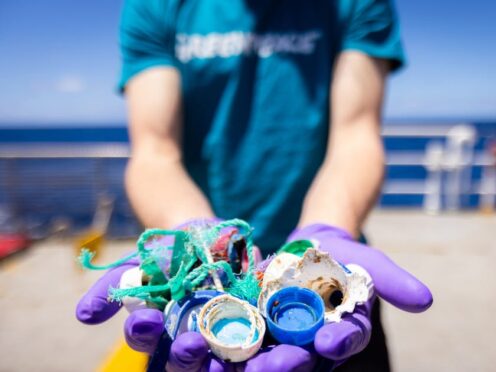 A member of Greenpeace holding up the plastic found in the Sargasso Sea in the Arctic ocean (Greenpeace/PA)