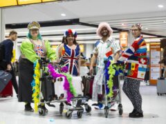 Eurovision fans prepare to board a special party flight from Gatwick (David Parry/PA)