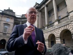 John Swinney has praised scrapping peak rail fares but says everything must be paid for (Andrew Milligan/PA)