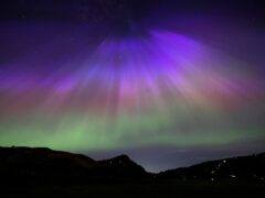The aurora borealis, also known as the northern lights, above Arthur’s Seat and Salisbury Crags in Holyrood Park, Edinburgh (Jane Barlow/PA)