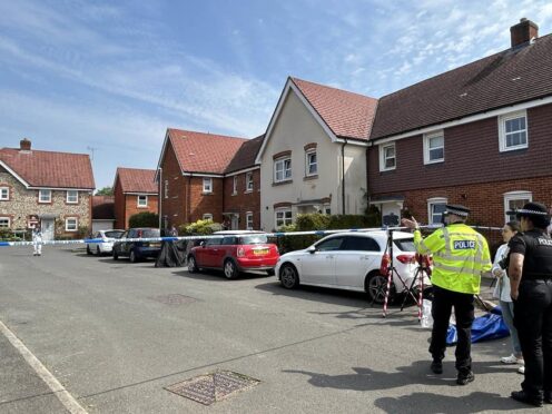 Police and forensic investigators at the scene in High Wycombe, Buckinghamshire after a police officer was shot in the leg with a crossbow after reports of a stabbing (Sam Hall / PA).