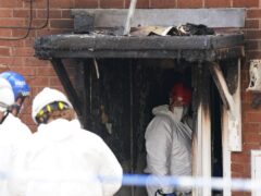 Forensic officers at the scene in Dunstall Hill area of Wolverhampton after two women died and four people were injured in a house fire, two men have been arrested on suspicion of murder. Picture date: Saturday May 11, 2024.