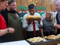 Prime Minister Rishi Sunak holds a loaf of bread in front of an obscured Morrisons logo during the second farm to fork summit on May 14 (Toby Melville/PA)