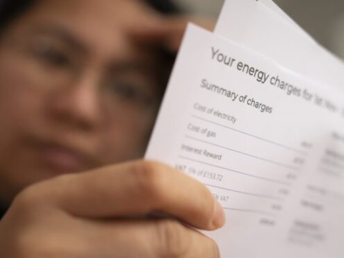 A person holding an energy bill (PA)
