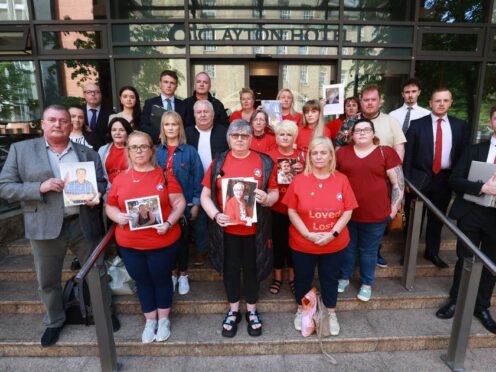 Brenda Doherty (front row centre) and members of Northern Ireland Covid-19 Bereaved Families for Justice hold a press conference outside the Clayton Hotel in Belfast (Liam McBurney/PA)