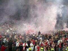 Southampton fans run onto the pitch after victory in the Sky Bet Championship play-off, semi-final, second leg match at St Mary’s Stadium (PA)