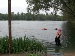 Swimmers at Shepperton Open Water Swim, a swimming spot at Ferris Meadow Lake in Surrey (Elena Giuliano/PA)