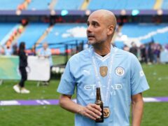 Pep Guardiola toasts Manchester City’s success (Martin Rickett/PA)