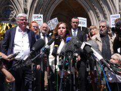 Stella Assange, the wife of Julian Assange, gives a statement outside the Royal Courts of Justice in London, after he won a bid at the High Court to bring an appeal against his extradition to the US (Lucy North/PA)
