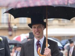 The Prince of Wales uses an umbrella during the Sovereign’s Garden Party (Yui Mok/PA)