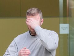 Matthew Trickett covering his face as he leaves Westminster Magistrates’ Court, central London, last week (PA)