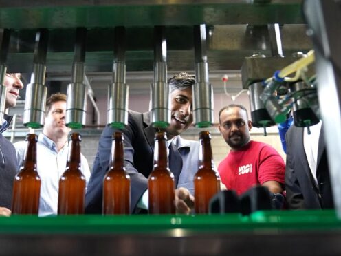 Prime Minister Rishi Sunak watching beer being bottled at the Vale of Glamorgan Brewery, in Barry, south Wales, while on the General Election campaign trail (Stefan Rousseau/PA)