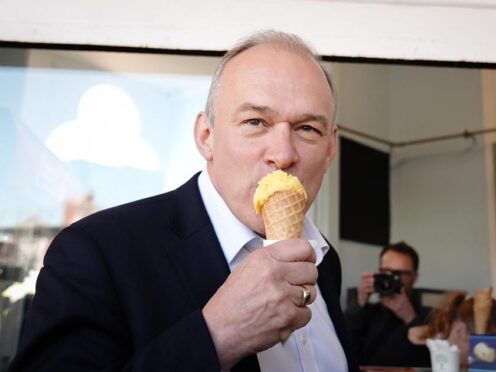Liberal Democrat leader Sir Ed Davey eats ice cream on the promenade in Eastbourne, East Sussex (Aaron Chown/PA)
