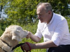 Liberal Democrat leader Sir Ed Davey went on a dog walk with supporters near Winchester (Andrew Matthews/PA)