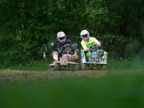 Competitors race in a heat during the World Lawnmower Championships (Andrew Matthews/PA)