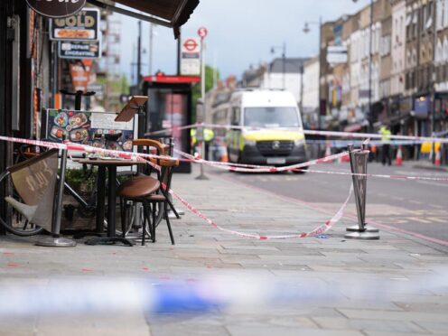 Police at the scene of a shooting at Kingsland High Street, Hackney, east London, where three adults and a child have been injured (James Manning/PA)