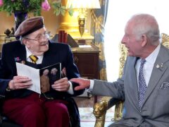 King Charles presented D-Day veteran Jim Miller with a card to mark his 100th birthday at Buckingham Palace (Chris Jackson/PA)