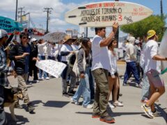 Locals march to protest the disappearance of foreign surfers in Ensenada, Mexico (Karen Castaneda/AP)