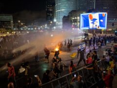 Police used water cannon to disperse demonstrators during a protest in Tel Aviv (Ariel Schalit/AP)