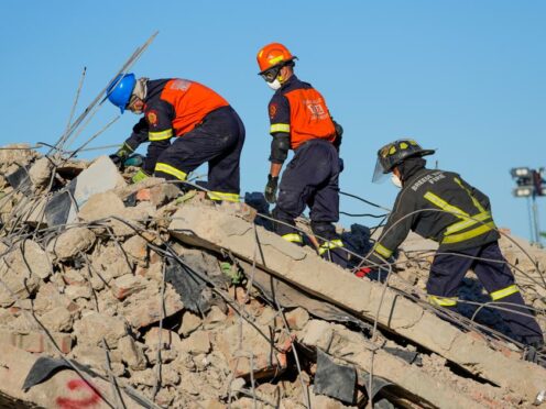 Rescue workers searching the site of the building collapse for survivors in George, South Africa, on Thursday (Jerome Delay/AP)