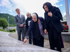 UK Minister of State (Minister for Europe) Nusrat Ghani, right, walks with Munira Subasic, president of the association Mother of Srebrenica, centre, next to the momument with the names of Srebrenica genocide victims, at the Memorial Centre in Potocari, Bosnia (Armin Durgut/AP)