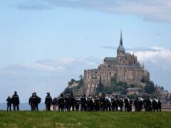 Gendarmes patrol at Mont Saint-Michel before the Olympic torch relay arrives (Jeremias Gonzalez/AP)