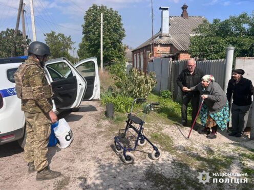 In this photo provided by the Ukrainian Police, police evacuate elderly people following the Russian attack around the town of Vovchansk in Kharkiv region, Ukraine, Friday, May 10, 2024. (Ukrainian Police via AP)