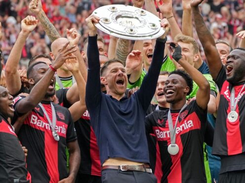 Xabi Alonso celebrates with the trophy after Bayer Leverkusen claimed the Bundesliga title (Martin Meissner/AP)