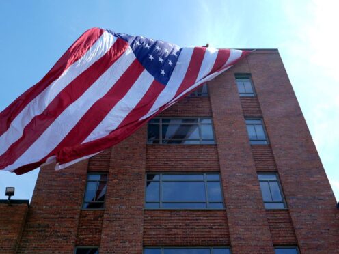 A giant American flag is unfurled on Lisner Hall on the campus of George Washington University in Washington (Susan Walsh/AP)