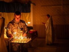 A Ukrainian serviceman lights candles during a Christian Orthodox Easter religious service in Donetsk (AP Photo/Francisco Seco)