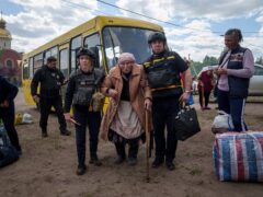 Rescue workers help Liudmila Kalashnik, 88, after evacuation from Vovchansk, Ukraine (Evgeniy Maloletka/AP)